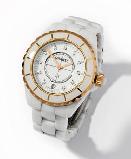 Chanel White Ceramic J12 Quartz Wristwatch: White ceramic wristwatch with stainless steel case and 18 Kt. yellow gold and ceramic bezel, surrounding a 29.00 mm. in diameter round white dial with gold baton shape hour and minute hands, hour posi