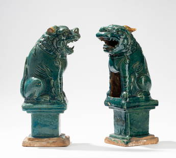 Pair of Chinese Porcelain Foo Dog Figures: Ming dynasty Each approximately: 14 x 4 1/2 x 7 in. (35.6 x 11.4 x 17.8 cm.) Provenance: Property from the Mary Pickford Estate, Beverly Hills, California