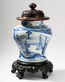 Chinese Blue and White Jar: depicting figures; with carved wood cover and stand; blue feather or leaf mark to underside 9 1/8 in. (23.2 cm.), Overall: 16 x 10 1/8 in. (40.6 x 25.7 cm.)