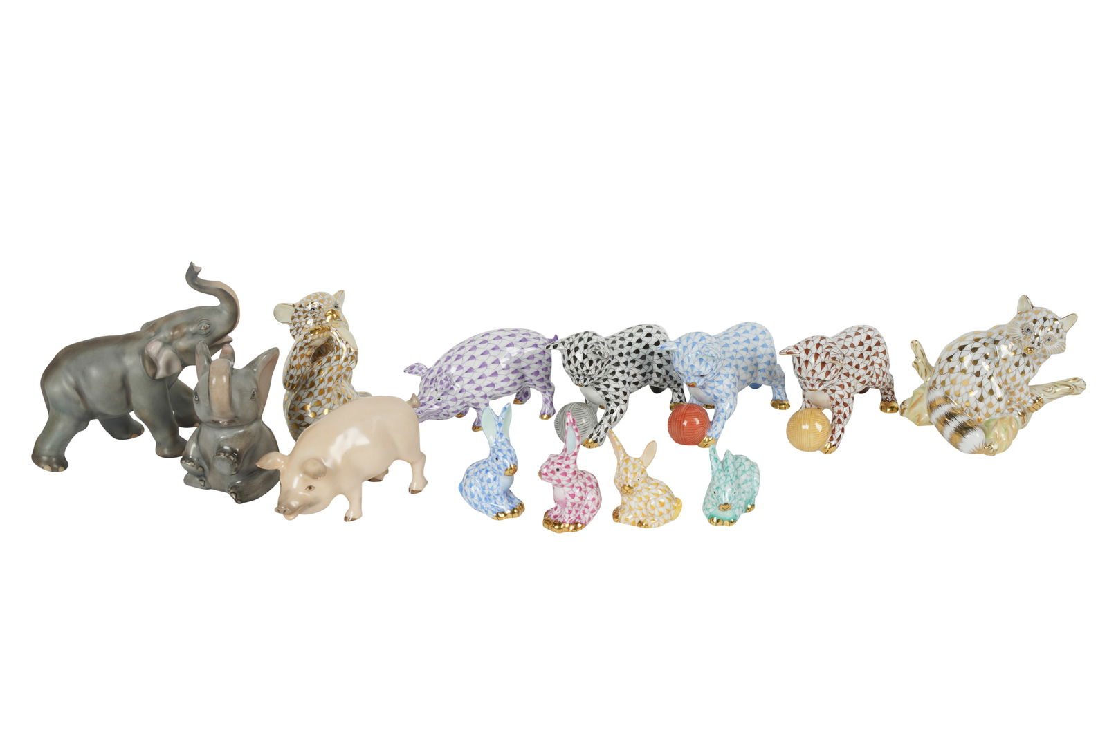 Group of Herend Porcelain Animal Figures: including three kittens, no. 15833 (4 1/8 in. wide); a gilt raccoon, no. 5854 (2 7/8 in. high); a gilt bear cub, no. 15484 (2 5/8 in. high); four rabbits; two elephants; and two pigs, no. 15301 (3 1/4