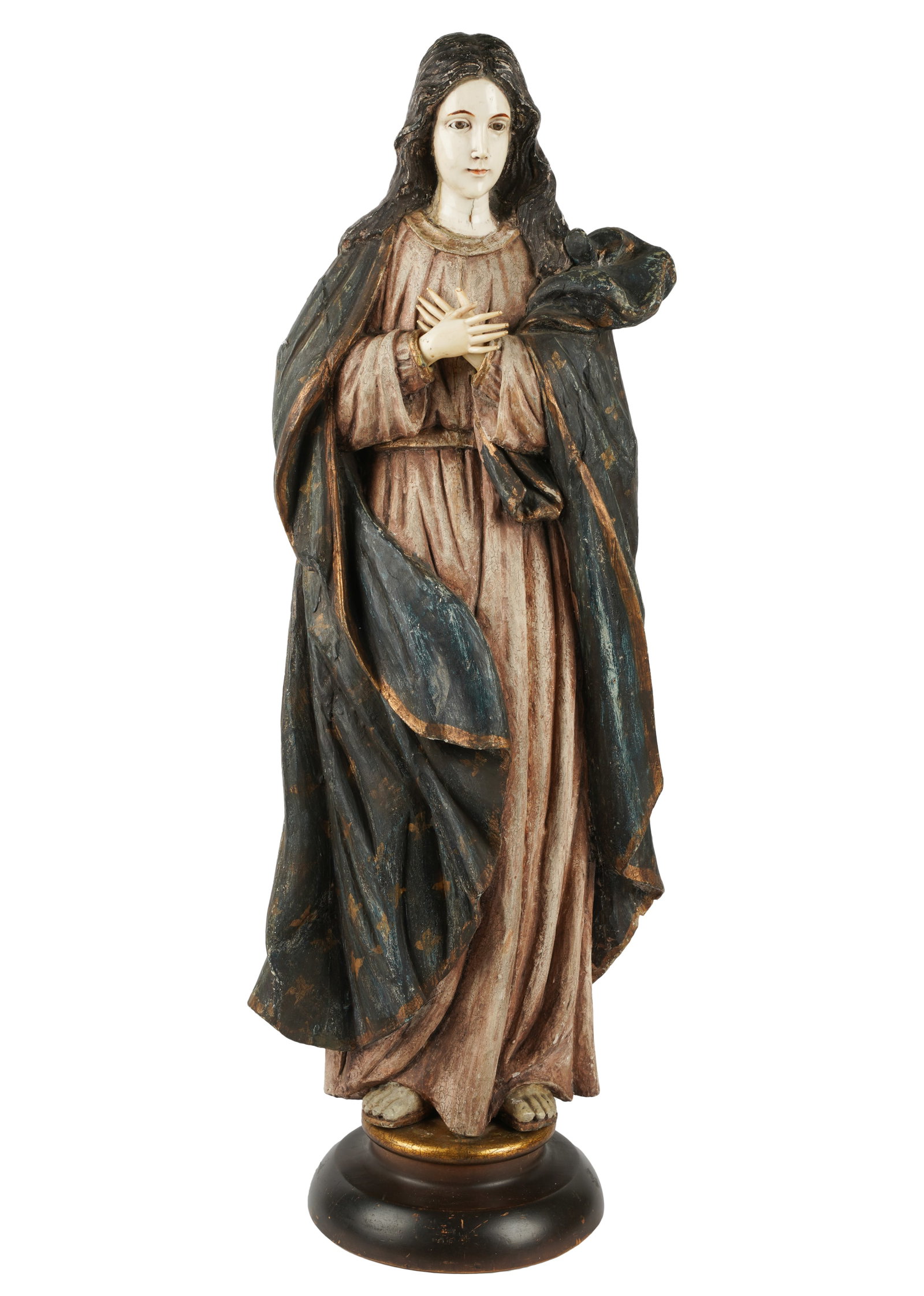 Carved and Polychrome-Painted Wood Figure of the Virgin Mary: set on a wooden base 34 1/2 x 13 x 9 in. (87.6 x 33 x 22.9 cm.) Provenance: The Walter and Donna Conn Estate; located within the desirable estate enclave of San Marino. Designed by the renowned archit