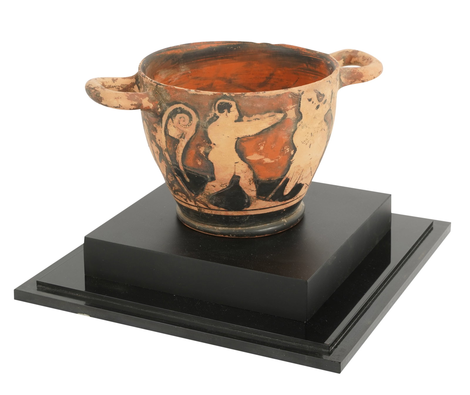 Painted Pottery Vessel: depicting figures; set on an ebonized wood base with acrylic case 4 x 7 7/8 x 5 in. (10.2 x 20 x 12.7 cm.), Case: 8 5/8 x 8 5/8 x 8 5/8 in. (21.9 x 21.9 x 21.9 cm.) Provenance: Property from the Estat