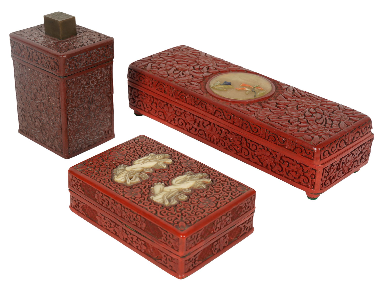 Group of Chinese Carved Cinnabar Boxes: each marked "China"; the first: inset with a hardstone medallion, with a divided interior ( 2 3/8 x 10 1/4 x 3 5/8 in.); the second: inset with carved bone figures, lacquered with an unlined and undiv