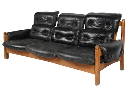 Mid-Century Safari-Style Sofa: in the style of Sergio Rodriguez; 1960s; black leather, stained wood 32 x 75 x 34 in. (81.3 x 190.5 x 86.4 cm.), Seat height: 14 in. (35.6 cm.)