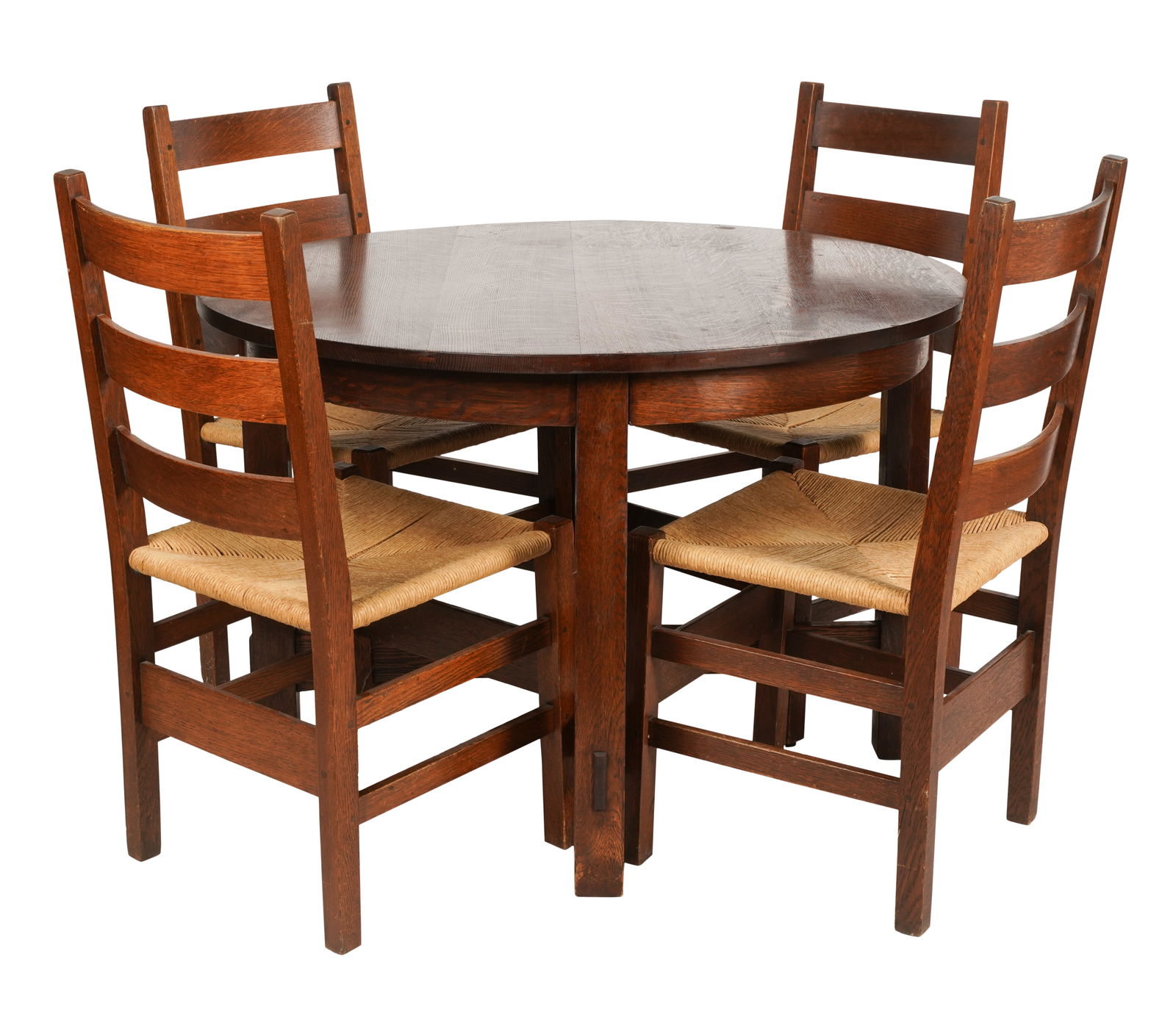 Arts and Crafts Oak Dining Table and Four Gustav Stickley Chairs: early 20th century; the table probably by Gustav Stickley, unsigned, 28 x 42 x 42 in. (71.1 x 106.7 x 106.7 cm.); the chairs with joiner's compass / als ik kan red decal mark, 35 1/2 x 17 x 16 1/2 in.