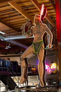 Vintage Native American with Tomahawk Neon Sign: with mechanical arm and leg (not operating), one side in complete working order and the other side only headdress portion working approximately: 129 x 62 x 15 in. (327.7 x 157.5 x 38.1 cm.)