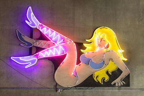 Vintage Pin-Up Girl Animated Neon Sign: painted wood mounted to a metal frame, with animation to leg approximately: 108 x 152 x 8 in. (274.3 x 386.1 x 20.3 cm.) Provenance: The Private Collection of Robin Chretien, founder of Robin's Jean;