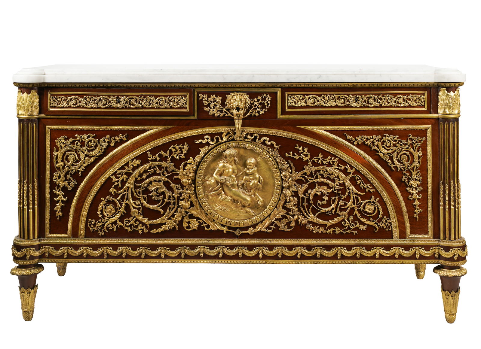 Gilt Bronze-Mounted Marble-Top Commode: with a central frieze drawer moiunted with a lion's mask, over two hinged front panels centered with a roundel depicting Aphrodite and Eros, opening to reveal six drawers 39 x 70 x 26 in. (99.1 x 177.