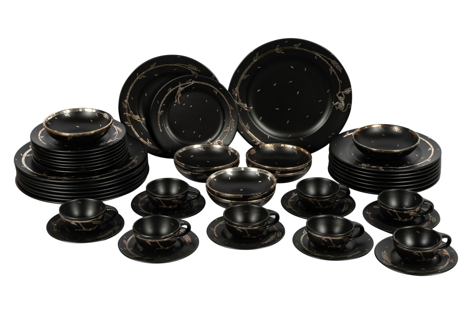 Emilia Castillo Silver Overlay Ceramic Service: monkey and vine pattern, comprising 8 dinner plates (11 1/2 in. dia.), 8 bowls (7 in. dia.), 8 salad plates (9 1/2 in. dia.), 8 round trays (13 in. dia.), 8 cups (2 1/2 in. high), and 8 saucers (7 1/2