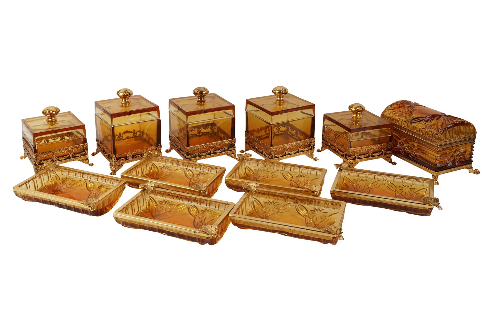 Collection of Amber Glass & Gilt Metal Vanity Pieces: comprising: five square boxes, one hinged box, and six dishes, square boxes marked "Made In Italy" to underside, amber glass with gilt metal humpback box: 4 3/4 x 8 x 5 1/4 in. (12.1 x 20.3 x 13.3 cm.