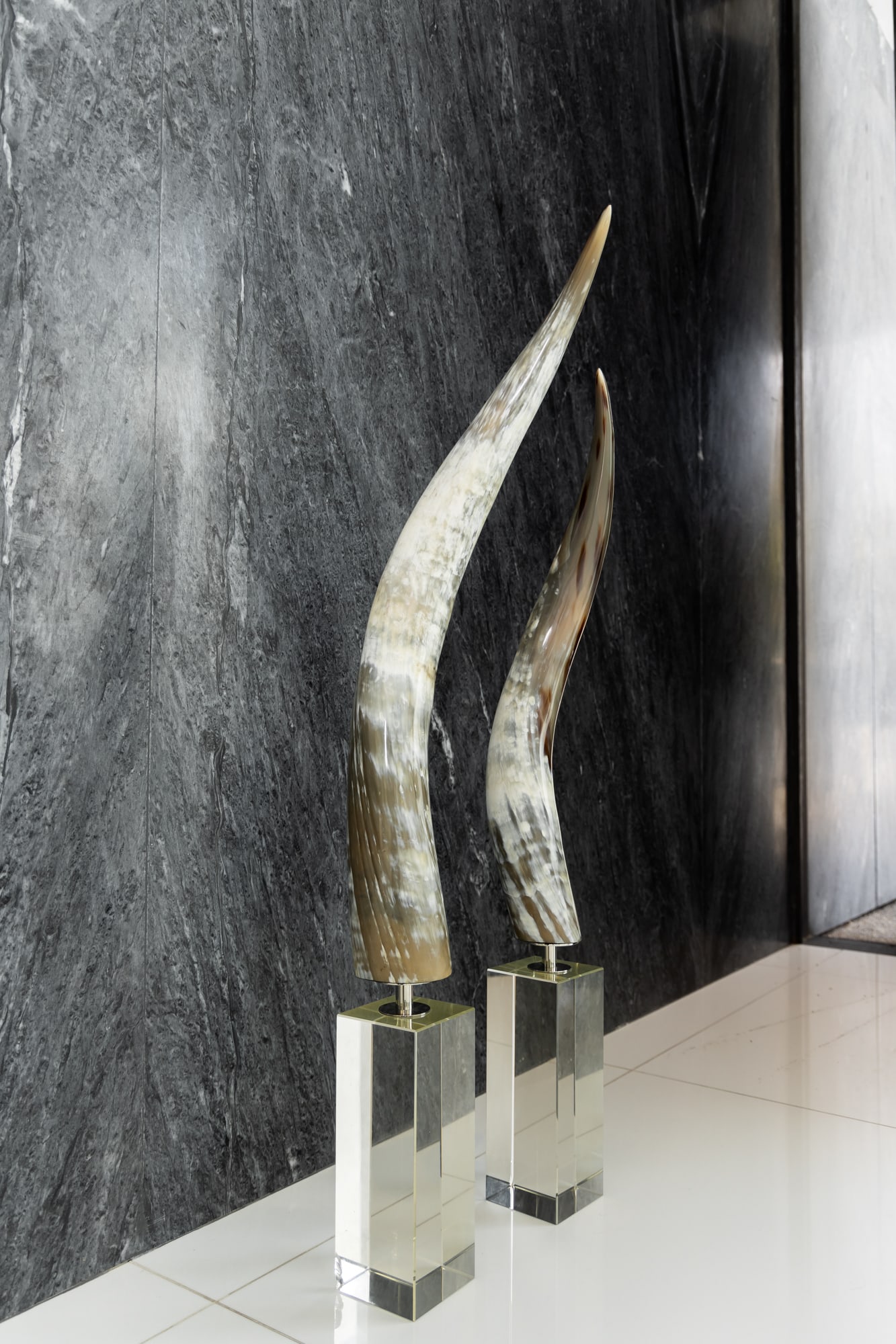 Two Graduated Horn Decorations: each mounted to molded glass base taller: 48 in. (121.9 cm.), shorter: 44 in. (111.8 cm.) Provenance: Beverly Hills private residence