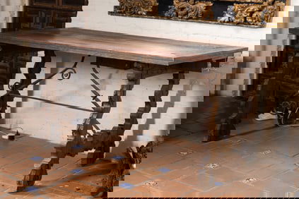 A Spanish Baroque Carved Walnut and Wrought Iron Table