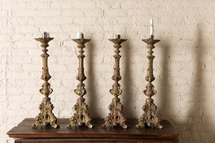 A Set of Four Continental Baroque-Style Cast Brass Altar Sticks