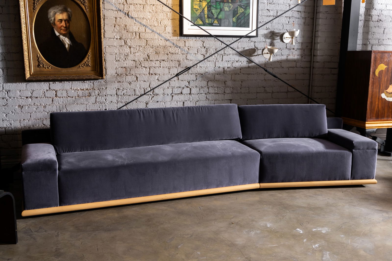 Adesso Imports Studio Line: Purple Velvet and Maple Sectional Sofa: 2020s; comprising a right-arm section, 24 x 83 x 33 in. (61 x 210.8 x 83.8 cm.) and a left-arm section, 24 x 48 x 33 in. (61 x 121.9 x 83.8 cm.), Seat height: 15 in. (38.1 cm.) Provenance: Property fr