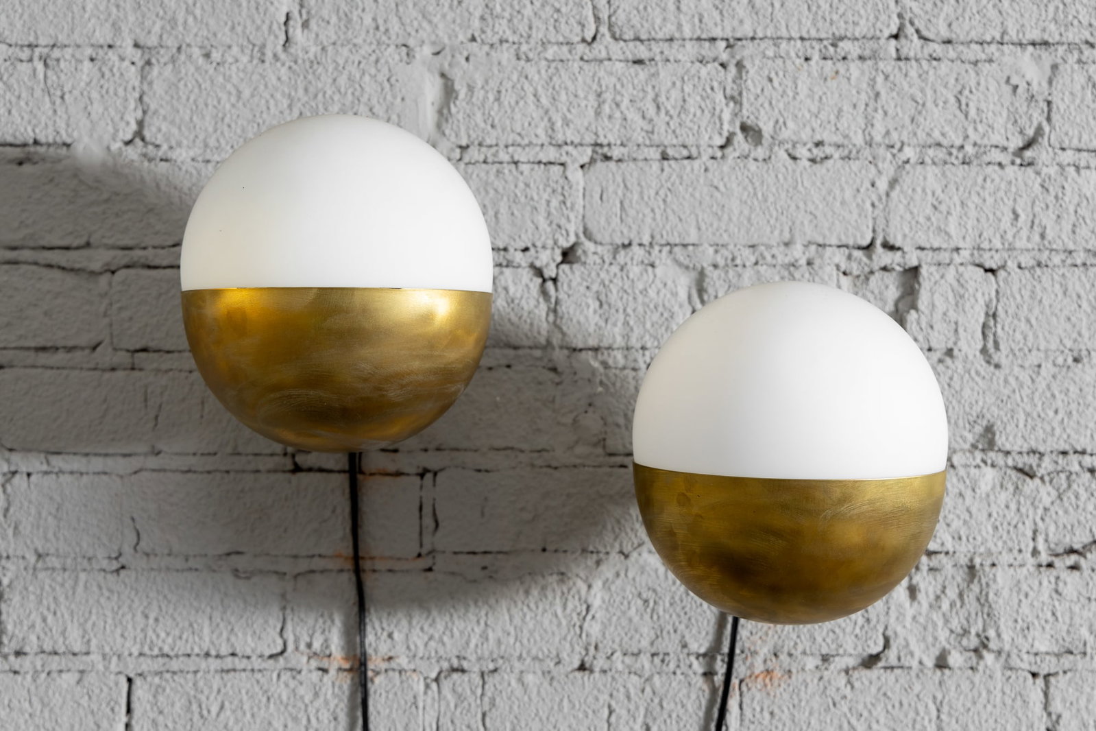 Stilnovo: Pair of Brass and Opaque Glass Sconces: mid 20th century 9 x 10 x 8 in. (22.9 x 25.4 x 20.3 cm.) Provenance: The Private Collection of International Architect and Designer Selma Cisic and the iconic Los Angeles store Adesso.