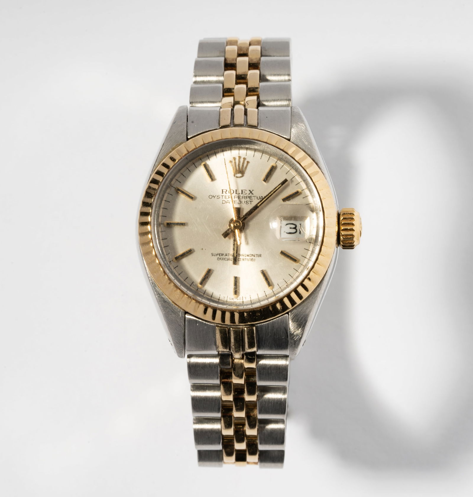 Rolex 18 Karat Yellow Gold & Stainless Steel Watch: 18 Kt. yellow gold and stainless-steel ROLEX "Oyster Perpetual Datejust" wristwatch with yellow gold crimped bezel surrounding a 20.00 mm. in diameter silver-tone dial, with baton shape hour, minute a