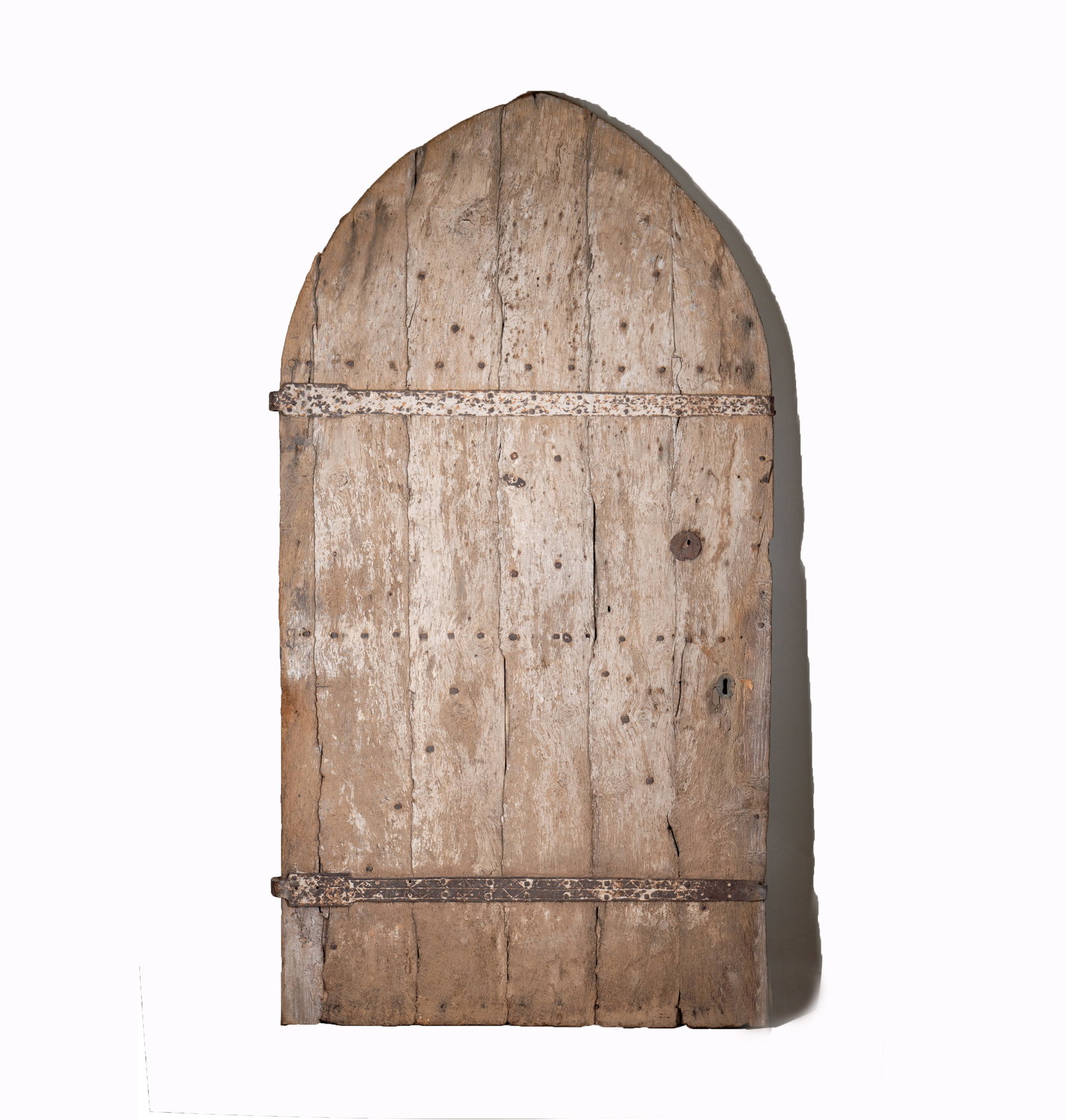 A Massive Gothic Arched Iron-Bound Wood Door: 16th century 97 x 51 x 3 in. (246.4 x 129.5 x 7.6 cm.) Provenance: with Foster-Gwin Gallery, San Francisco, California; with Rossi Antiques and Custom Furniture, San Francisco, California