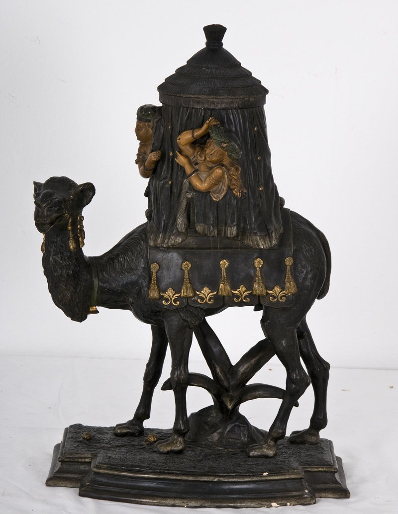 CONTINENTAL PAINTED TERRA COTTA CAMEL-FORM HUMIDOR: initialed "W.S." below depicting a draped tent with figures atop a camel 13 inches wide; 21 inches high