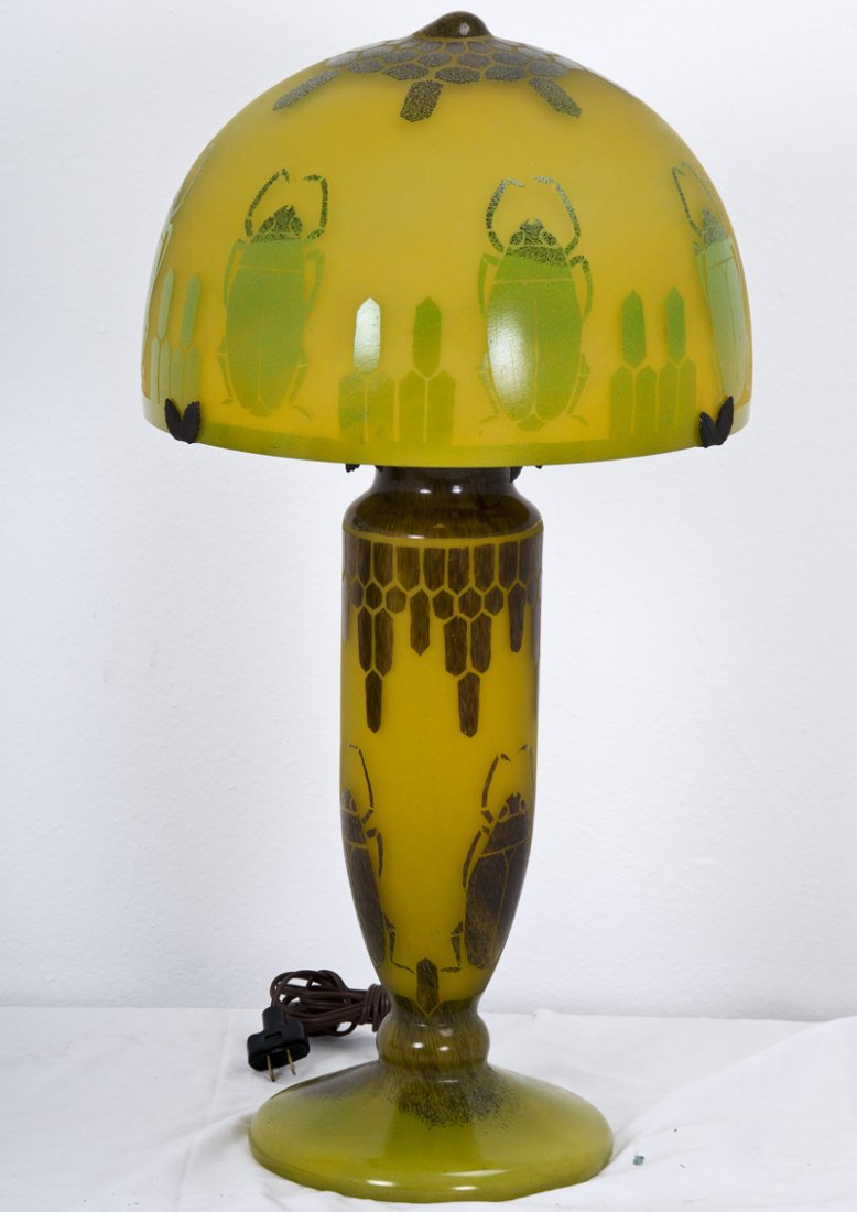 CHARDER ACID ETCHED AND CAMEO ART GLASS TABLE LAMP: the domed shade and base depicting scarabs on a yellow ground the shade measuring 13 1/2 inches diameter; 27 1/2 inches high