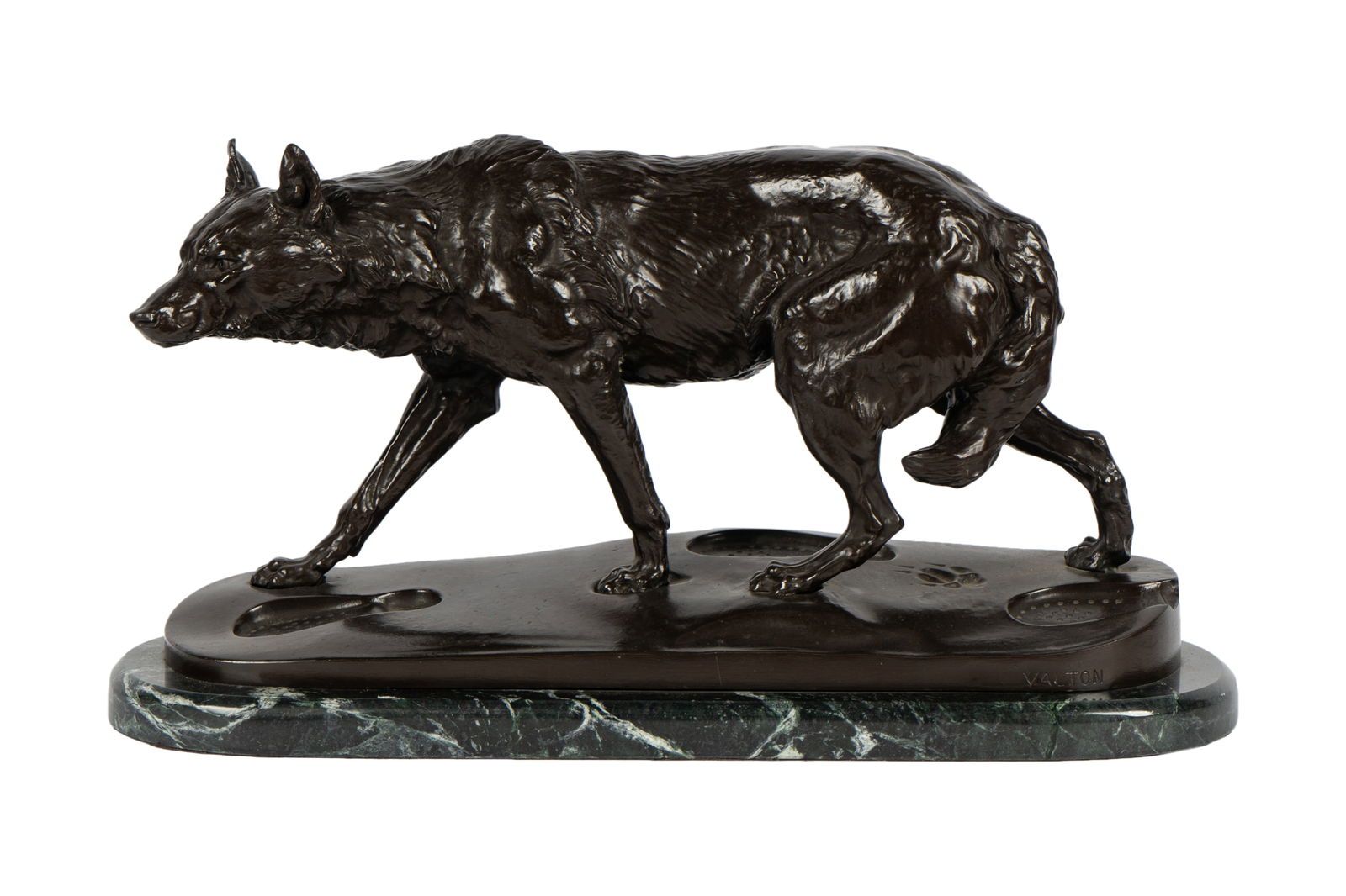 After Charles Valton (1851-1918): Stalking Wolf: bronze with brown patination, mounted to green marble plinth; depicted following shoe prints across the integral base; incised "Valton" (no edition number or foundry mark) Bronze: 11 1/2 x 21 1/2 x 6