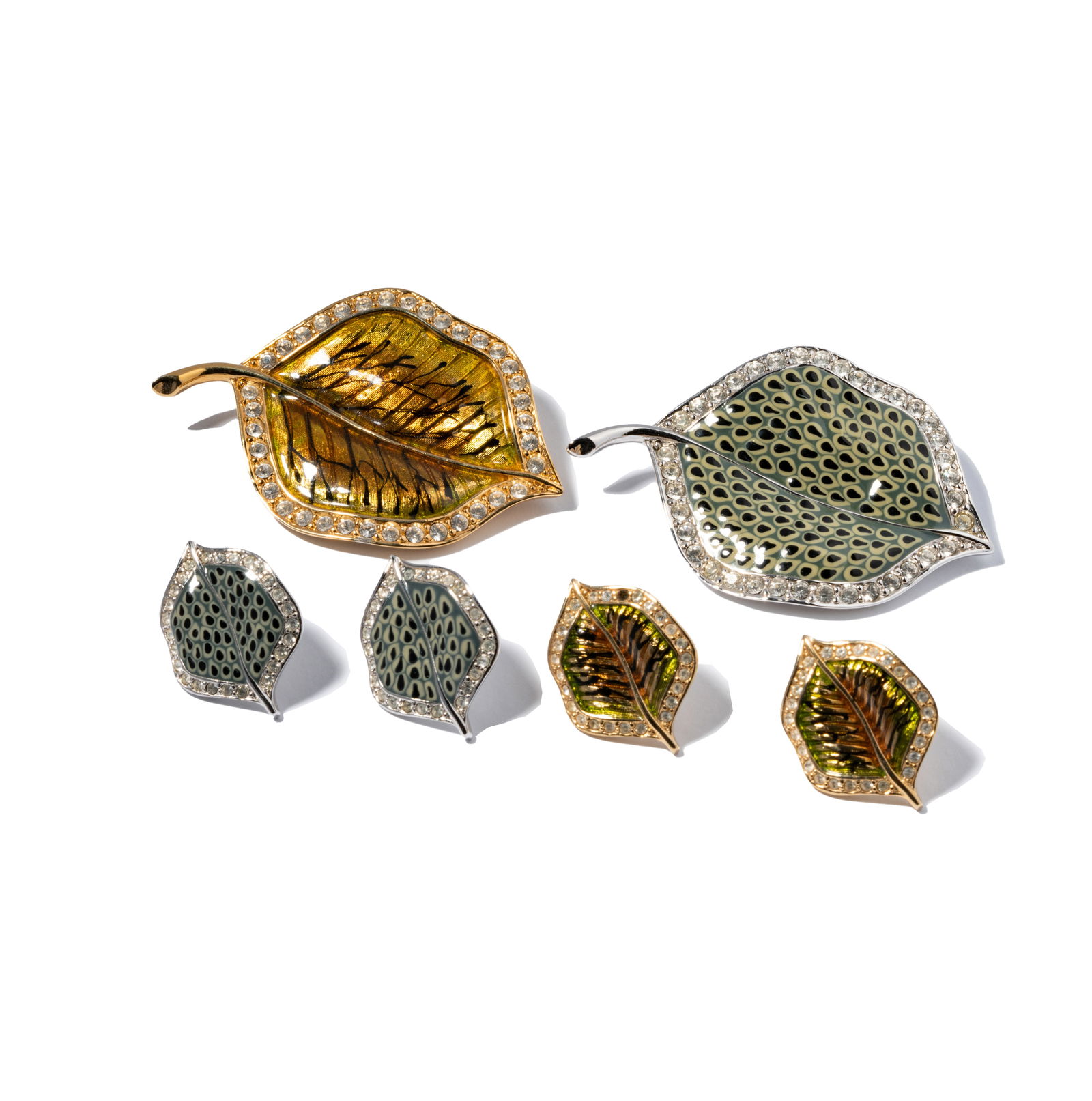 Erwin Pearl Two Groups Of Leaf Jewelry: Two pairs of base metal and rhinestone leaf brooch and earrings sets;