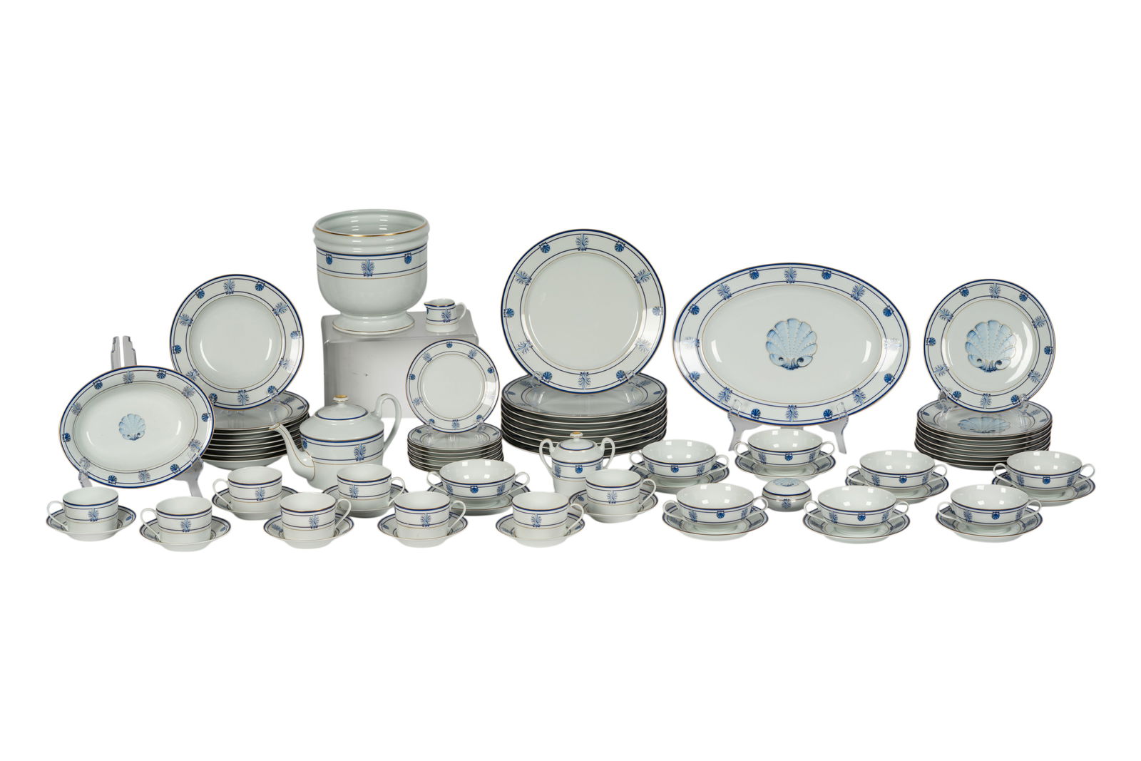 A Tiffany and Co. Porcelain Service: "Shell and Thread" pattern; comprising eight dinner plates (10.75 in. dia.), eight salad plates (8.625 in. dia.), eight soup plates (8.75 in. dia), eight bread plates (8 in. dia.), eight cups, eight s
