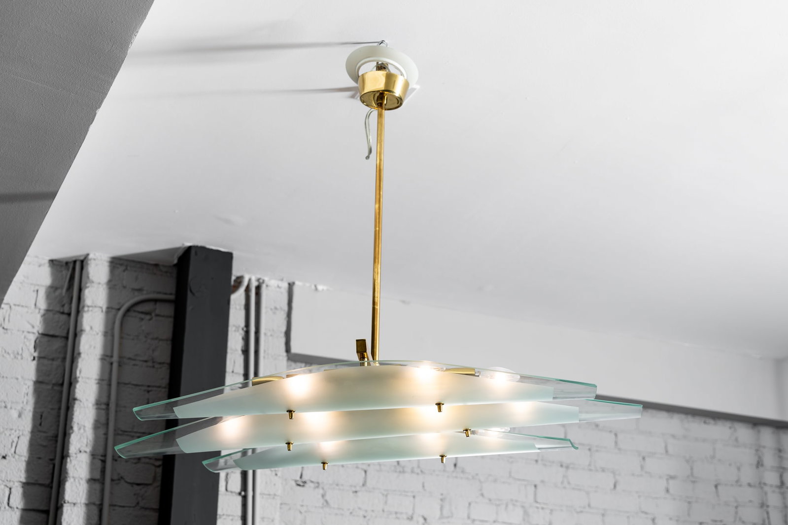 Dominici: Glass and Brass Chandelier: Italy, 1960s; with three clear and frosted glass disks suspended on a brass frame 30 x 39 1/2 x 29 in. (76.2 x 100.3 x 73.7 cm.) Provenance: Property from The Private Collection of International Archi