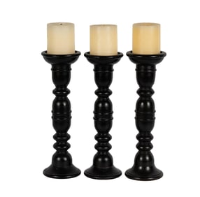 A Set of Three Ebonized Wood Candlesticks