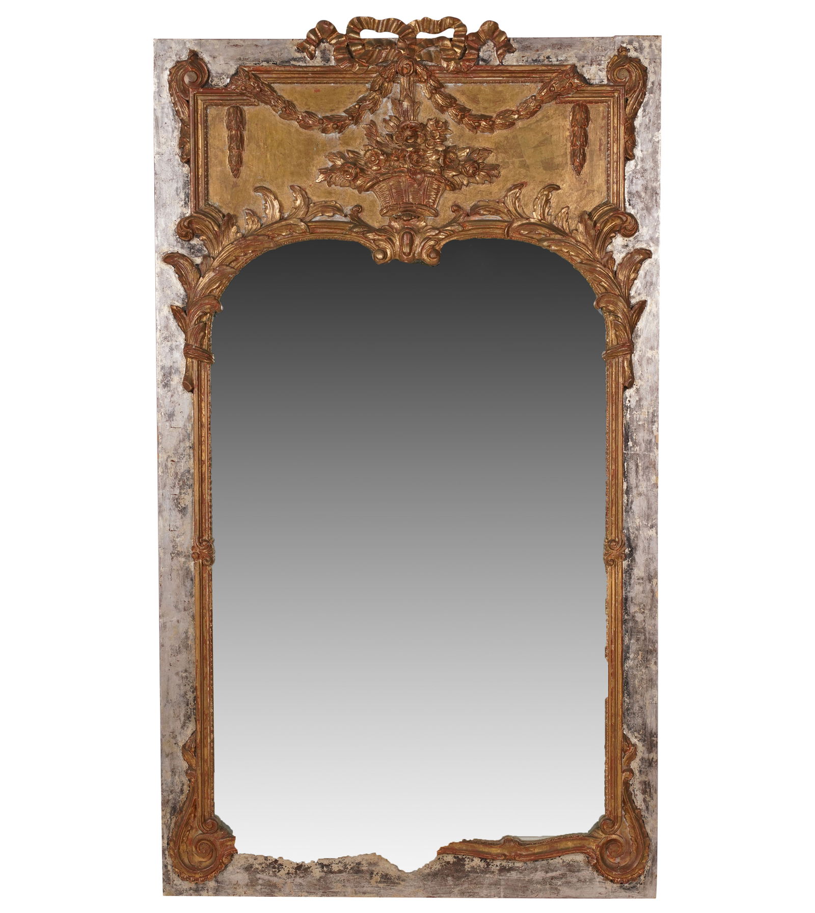 A Minton-Spidell Gilwood Mirror: the flat mirror plate within a carved giltwood surround mounted on a silver-painted panel 64 x 36 1/2 in. (162.6 x 92.7 cm.)