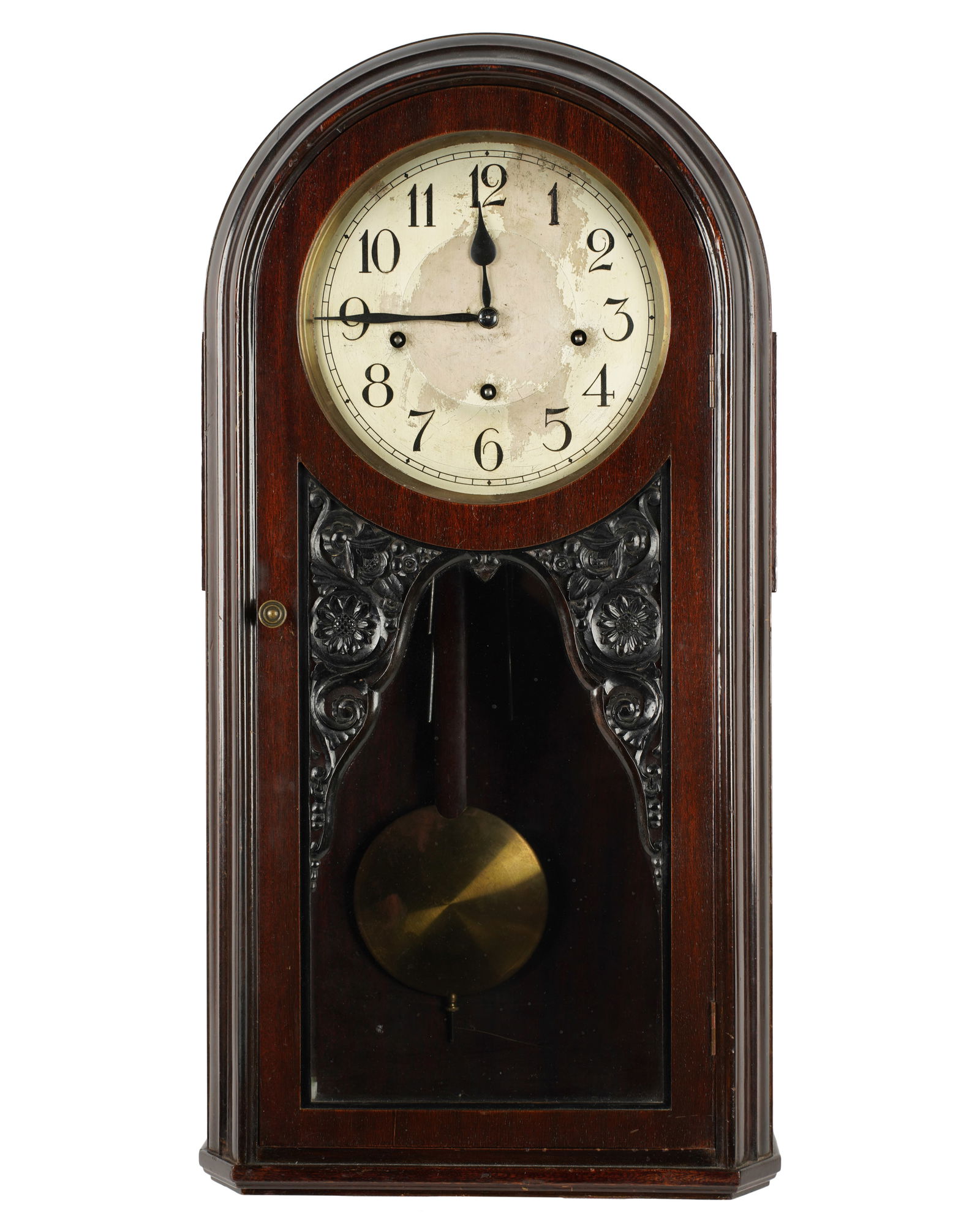 A Mahogany Wall Clock: the glazed door with carved spandrels; unsigned 27 3/4 x 13 x 6 in. (70.5 x 33 x 15.2 cm.)