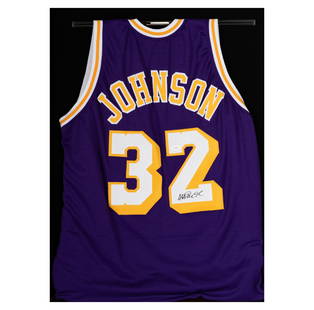 A Magic Johnson Signed Lakers Jersey: hanging from an acrylic rod in front of a black fabric backing within a hinged-front frame Frame: 31 1/2 x 23 1/2 in. (80 x 59.7 cm.)