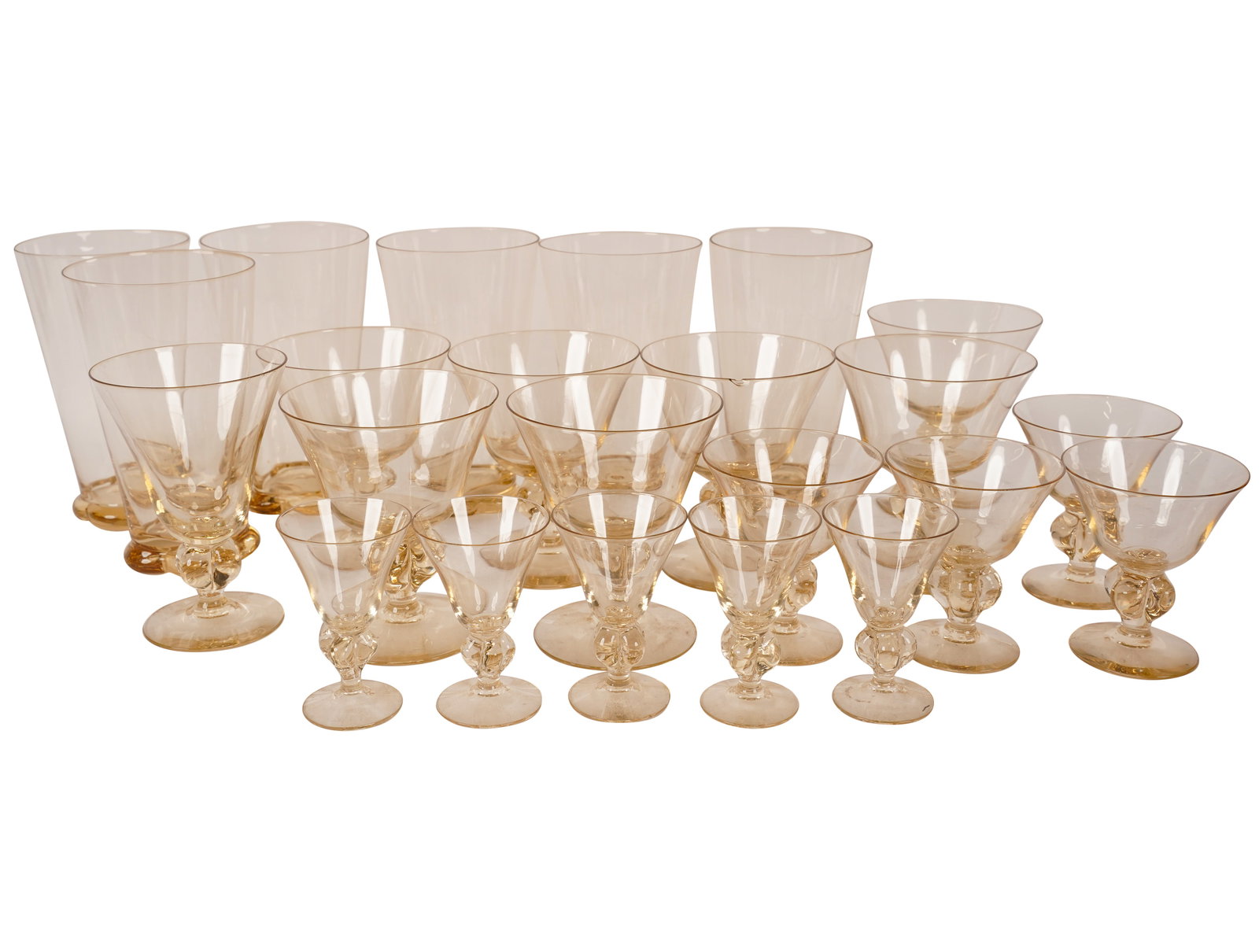 A Glass Stemware Service: in the style of Steuben, each in clear shaded to amber color; comprising five liqueurs (3 1/8 in. high), four sherry (3 1/2 in. high), seven coupes (4 1/4 in. high), one wine (4 3/4 in. high), and six