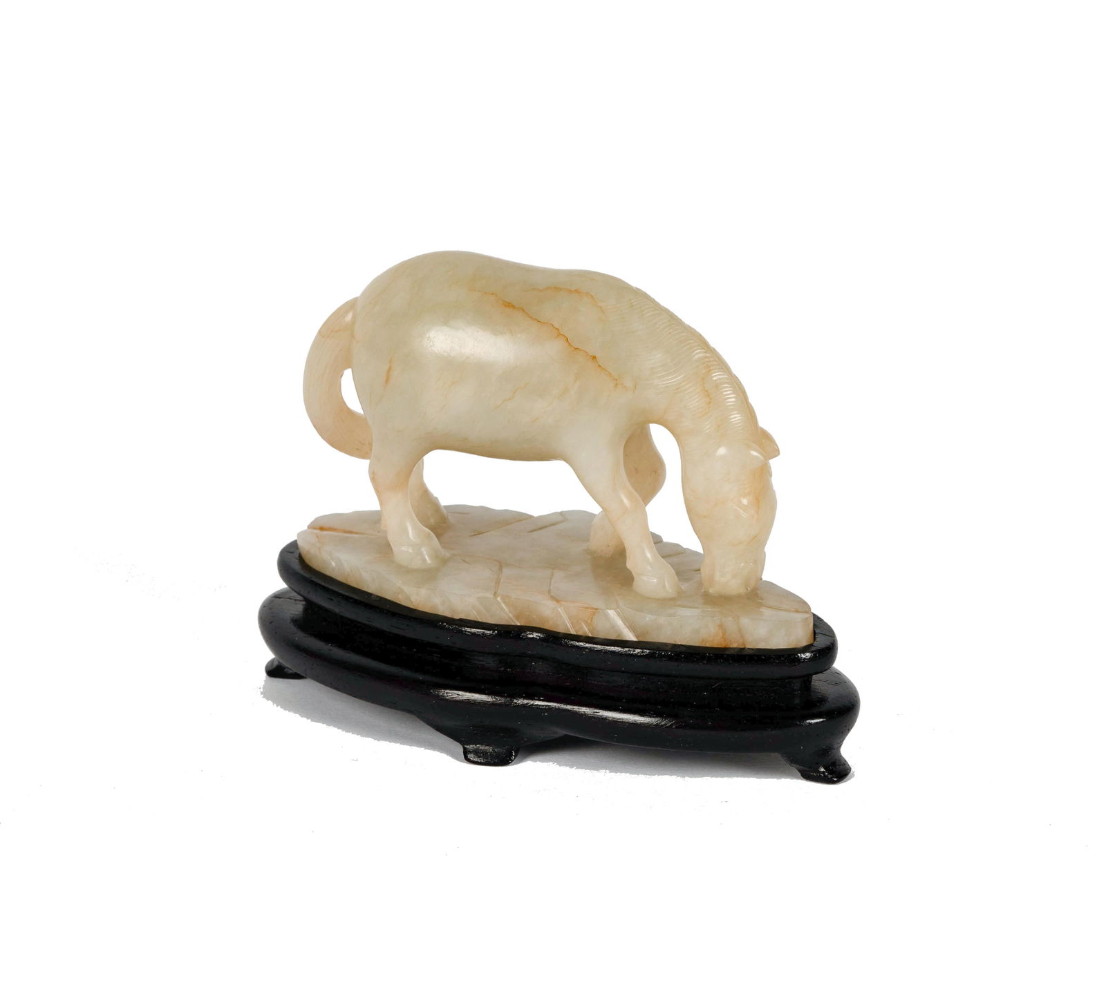 A Chinese Carved White Jade Figure of a Horse: with a wooden stand Figure: 2 1/8 x 3 1/2 x 1 3/4 in. (5.4 x 8.9 x 4.4 cm.), Overall: 3 x 4 x 2 in. (7.6 x 10.2 x 5.1 cm.) Provenance: Property from the Bing Estate, Boston, Massachusetts