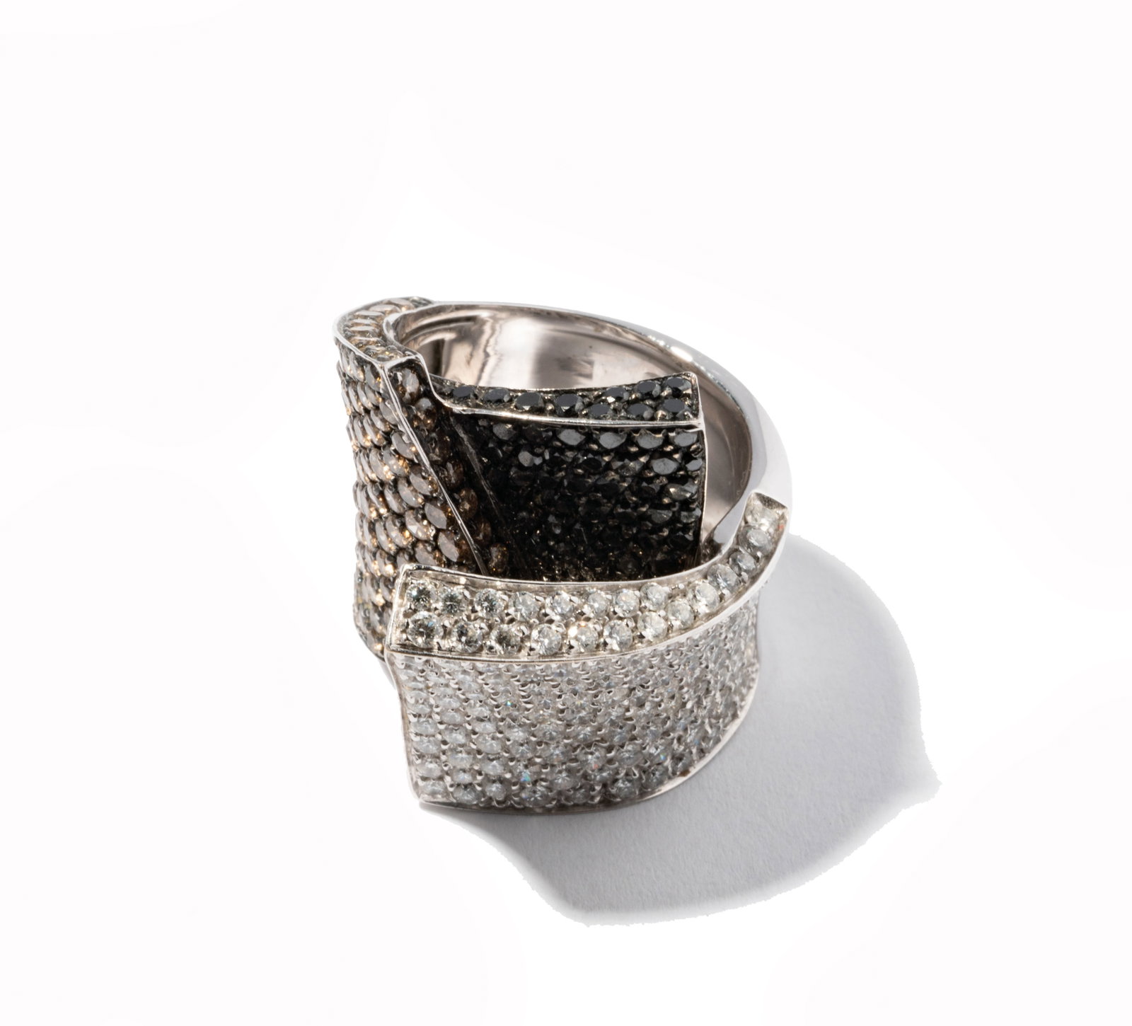 18 Karat White Gold, Diamond and Colored Diamond Ring: white gold abstract band-style ring pave' set with 58 full cut round Diamonds [Fancy Black], approximate total weigh 0.59 ct., enhanced with 125 full cut round Diamonds [Fancy Light Brown/I-1], approx