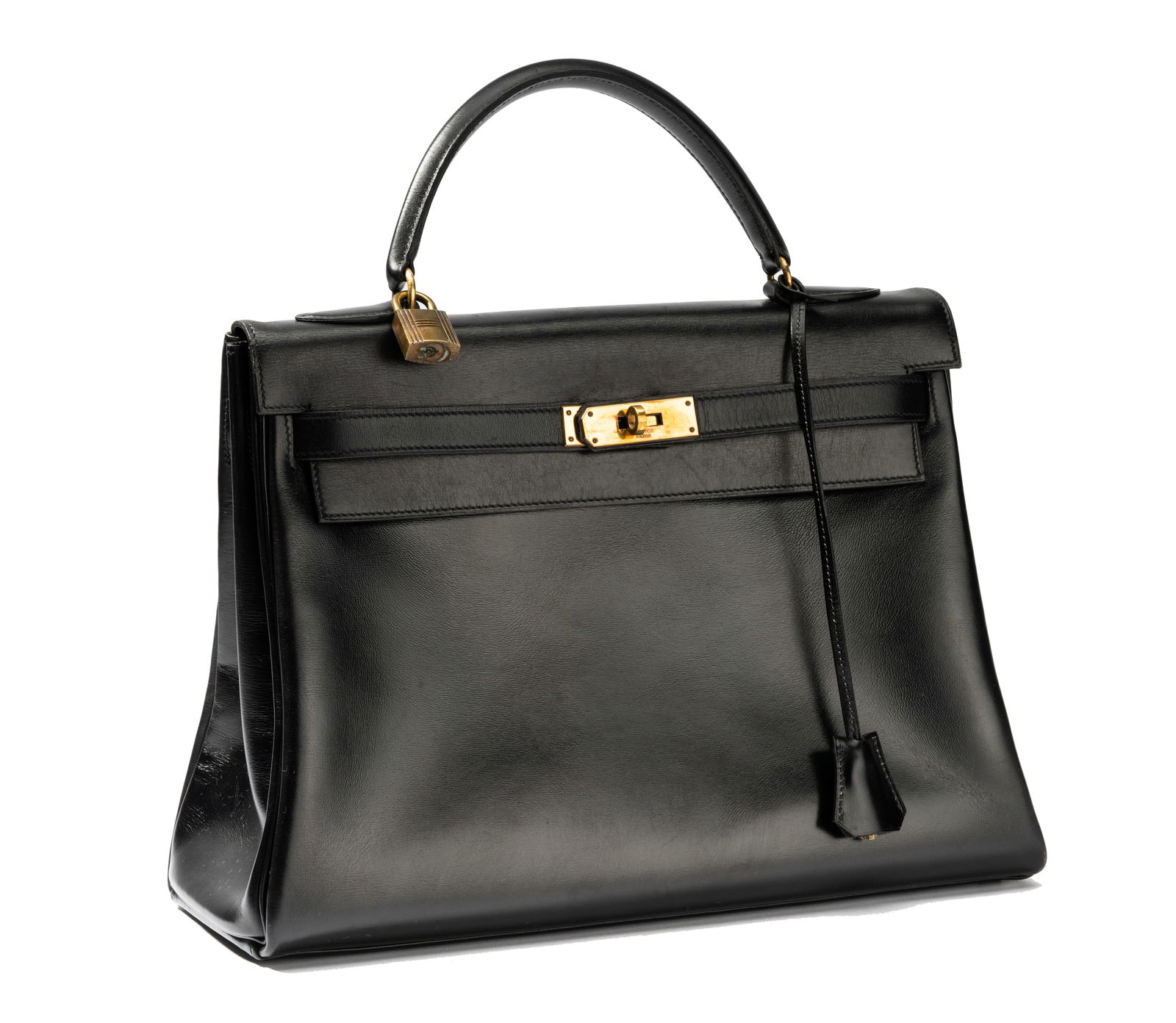 A Hermes Black Calf Box Leather Retourne Kelly Bag: size: 32cm; stamped with date code 'G' for 1951 to latch clasp; with later box, dust bag; 9 x 12 1/2 x 5 in. (22.9 x 31.8 x 12.7 cm.)