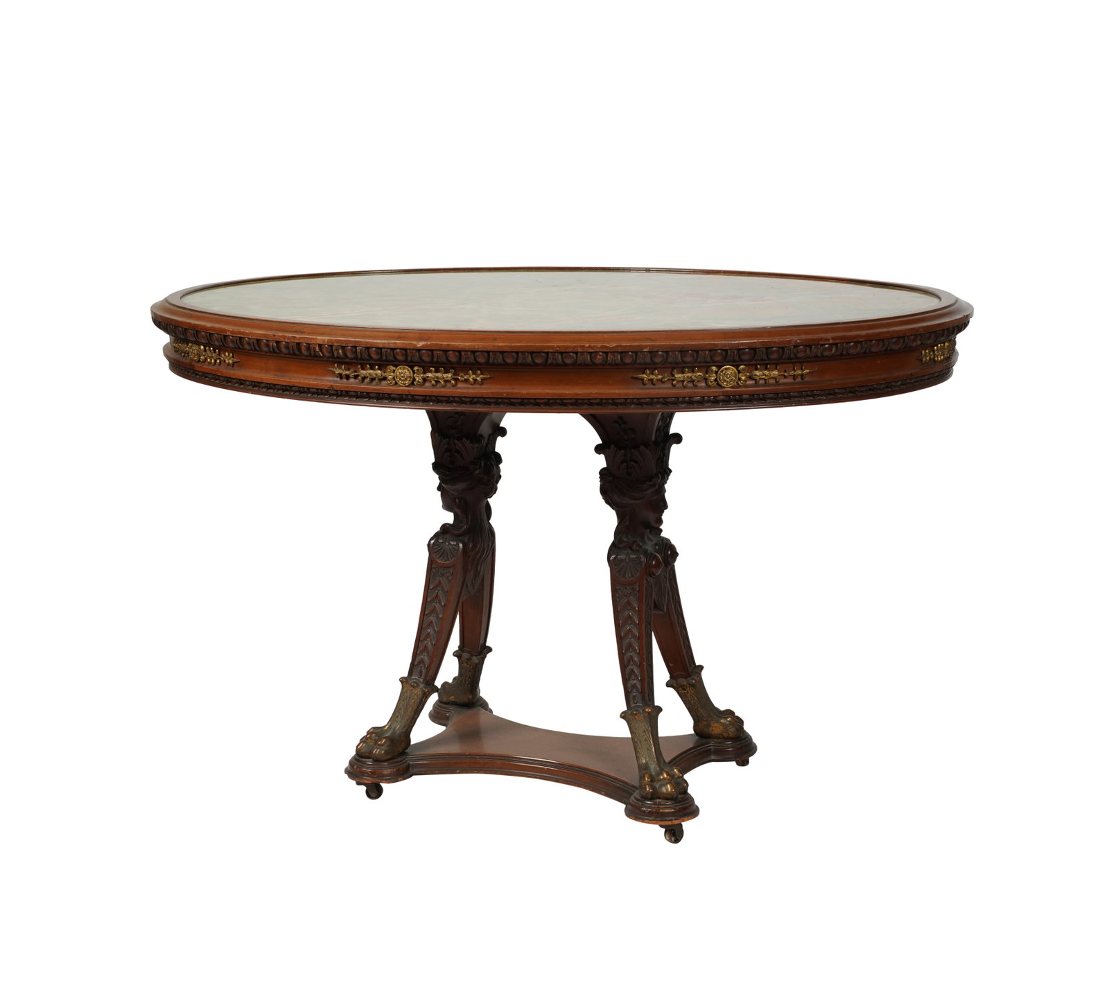 A Victorian Empire-Revival Green Onyx and Mahogany Center Table: late 19th century; the oval top inset with a full sheet of green onyx, the frieze with gilt metal mounts30 x 47 1/2 x 37 in. (76.2 x 120.7 x 94 cm.)