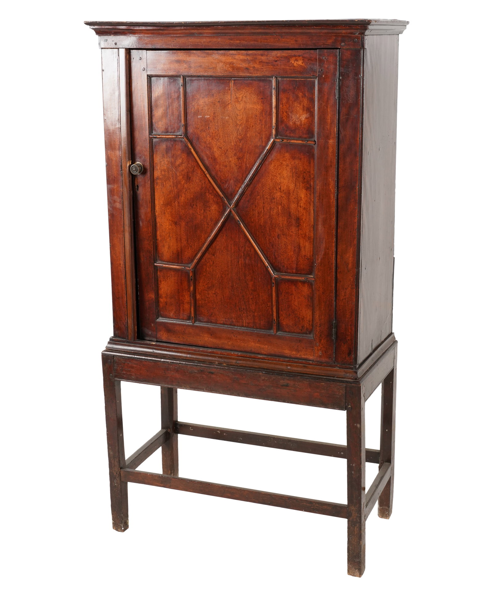 An English Mahogany Cabinet On Stand: 19th century; in two parts Overall: 62 x 33 x 17 in. (157.5 x 83.8 x 43.2 cm.)