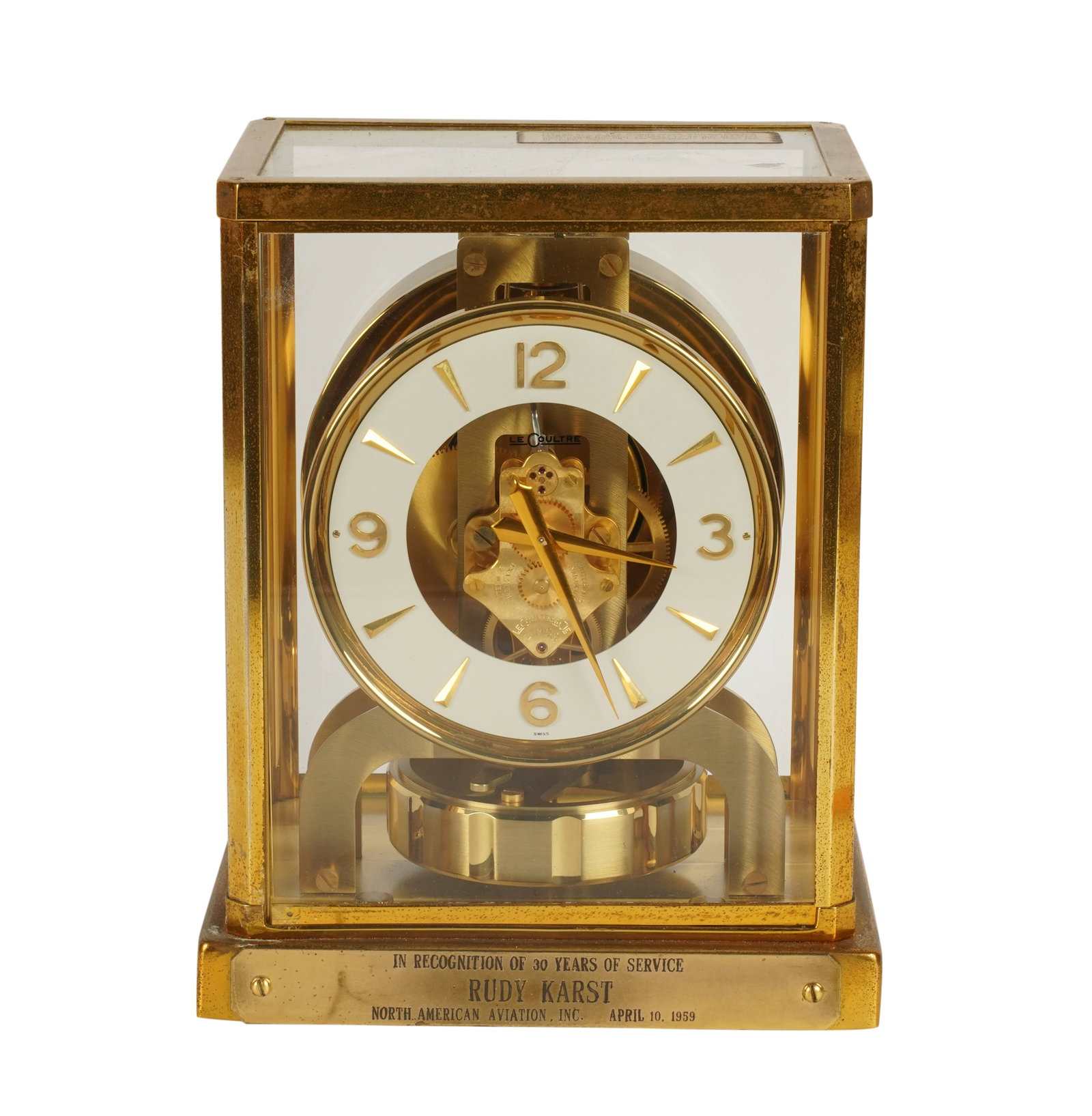 A Le Coultre Atmos Clock: brass and glass; with engraved inscription to front of base dated 1959 9 x 7 x 5 1/2 in. (22.9 x 17.8 x 14 cm.)