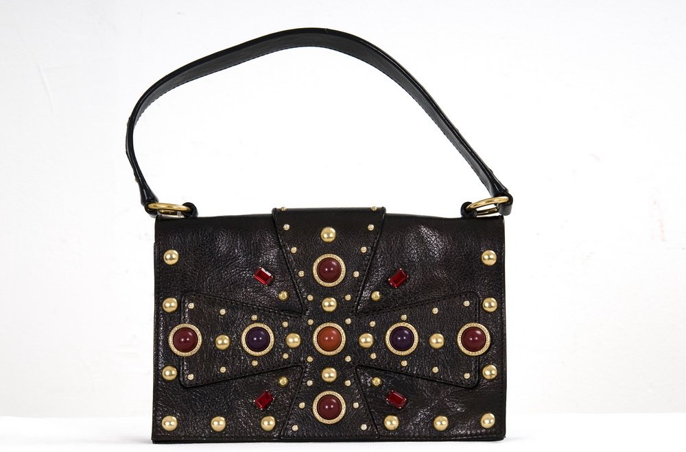 YVES SAINT LAURENT JEWELED LEATHER HANDBAG: Rive Gauche handbag with two divided compartments; the front with a maltese cross design and studded with brass and jewel tone embellishments 7 inches high; 10.5 inches wide; 7.5 inch shoulder strap