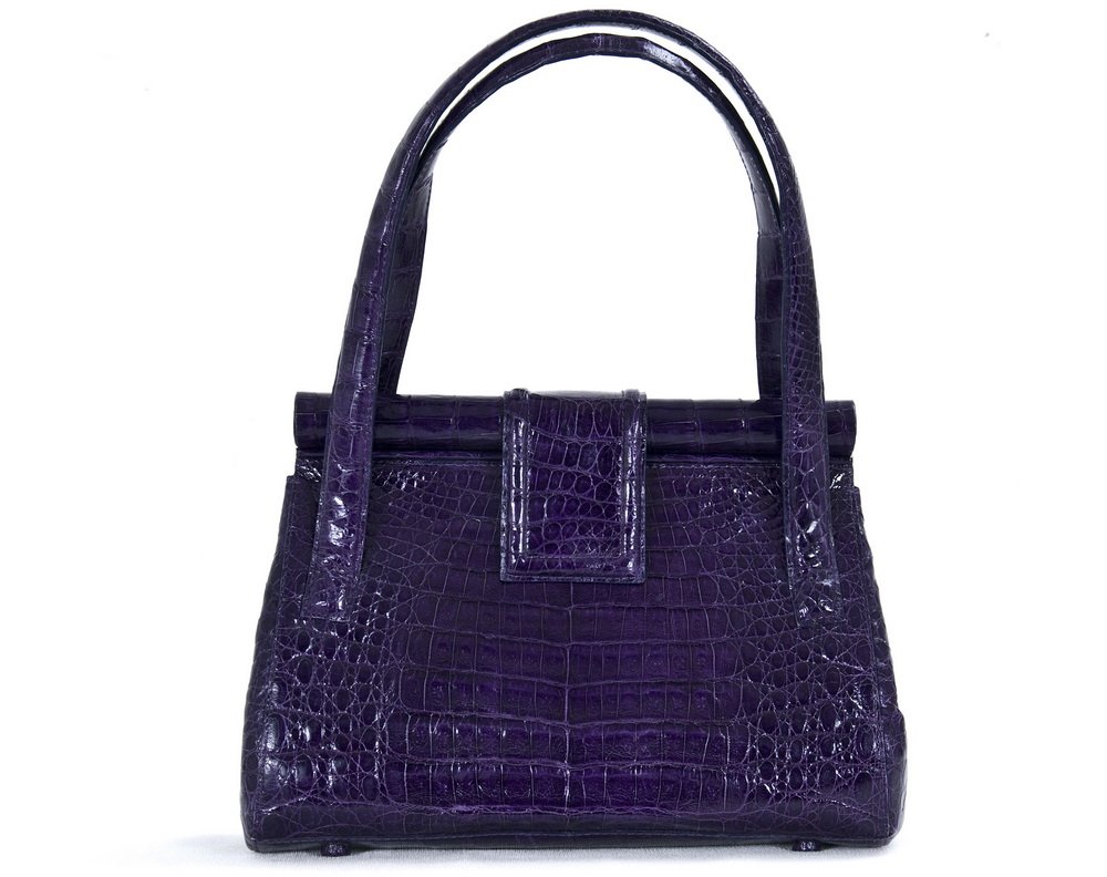 NANCY GONZALEZ PURPLE CROCODILE TOTE: Structured A-frame body; magnetic clasp; zipper compartment and protective feet Made in Columbia 8 inches high; 10 inches wide; 4 inch drop from handles