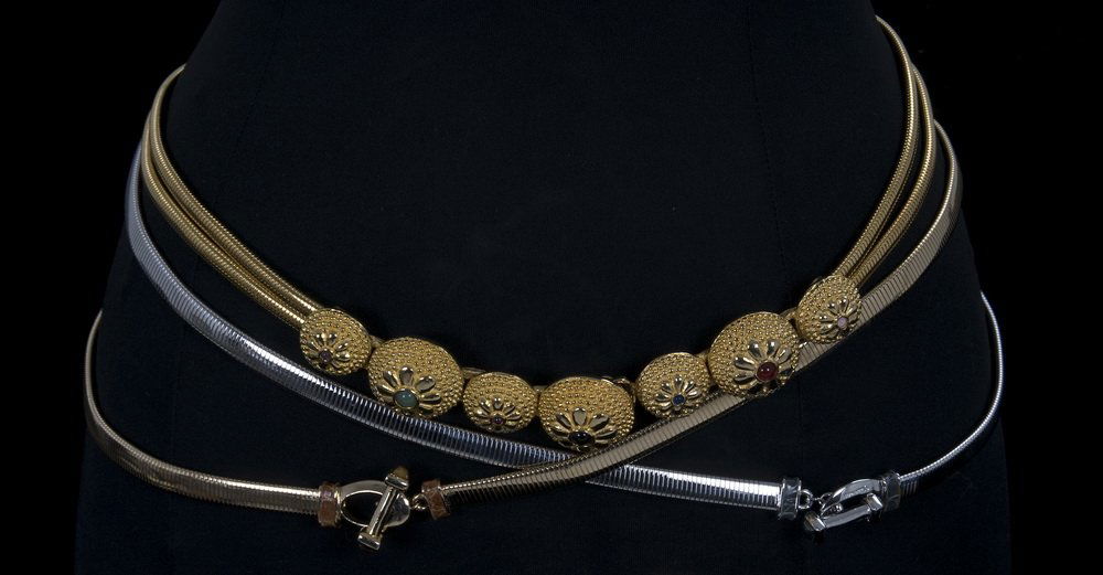 THREE JUDITH LEIBER METAL STRETCH BELTS: Two are gold metal and one is silver metal