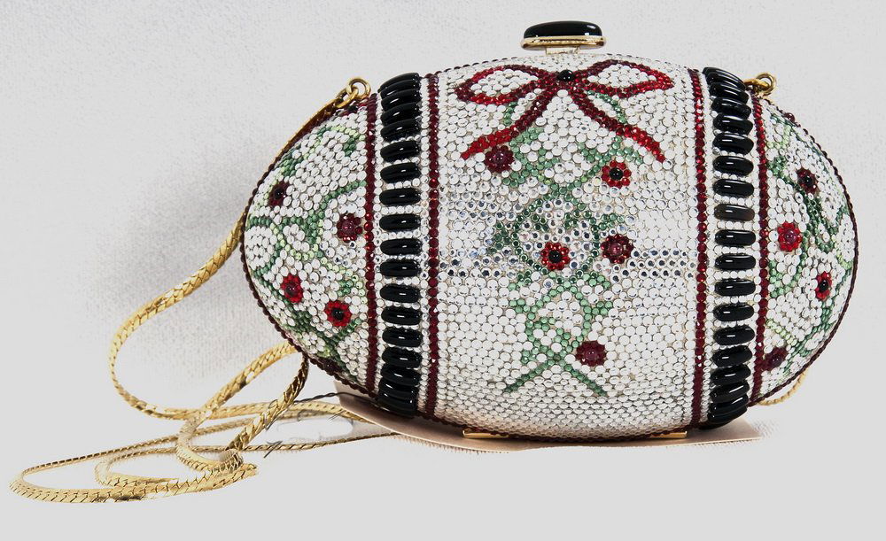 JUDITH LEIBER EGG EVENING MINAUDIERE: Patterned egg with flowers and bows on silver body; drop in chain; gold leather interior; includes comb, coin purse, and mirror 4.5 inches high; 6 inches wide; 2.5 inches deep