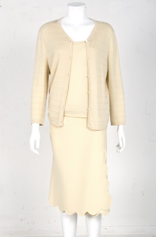OSCAR DE LA RENTA THREE PIECE CREAM SUIT: Skirt and sweater set featuring a wool A-line skirt with scalloped hemline; together with a soft knit shell and sweater Skirt: size 12; Sweater set: size large