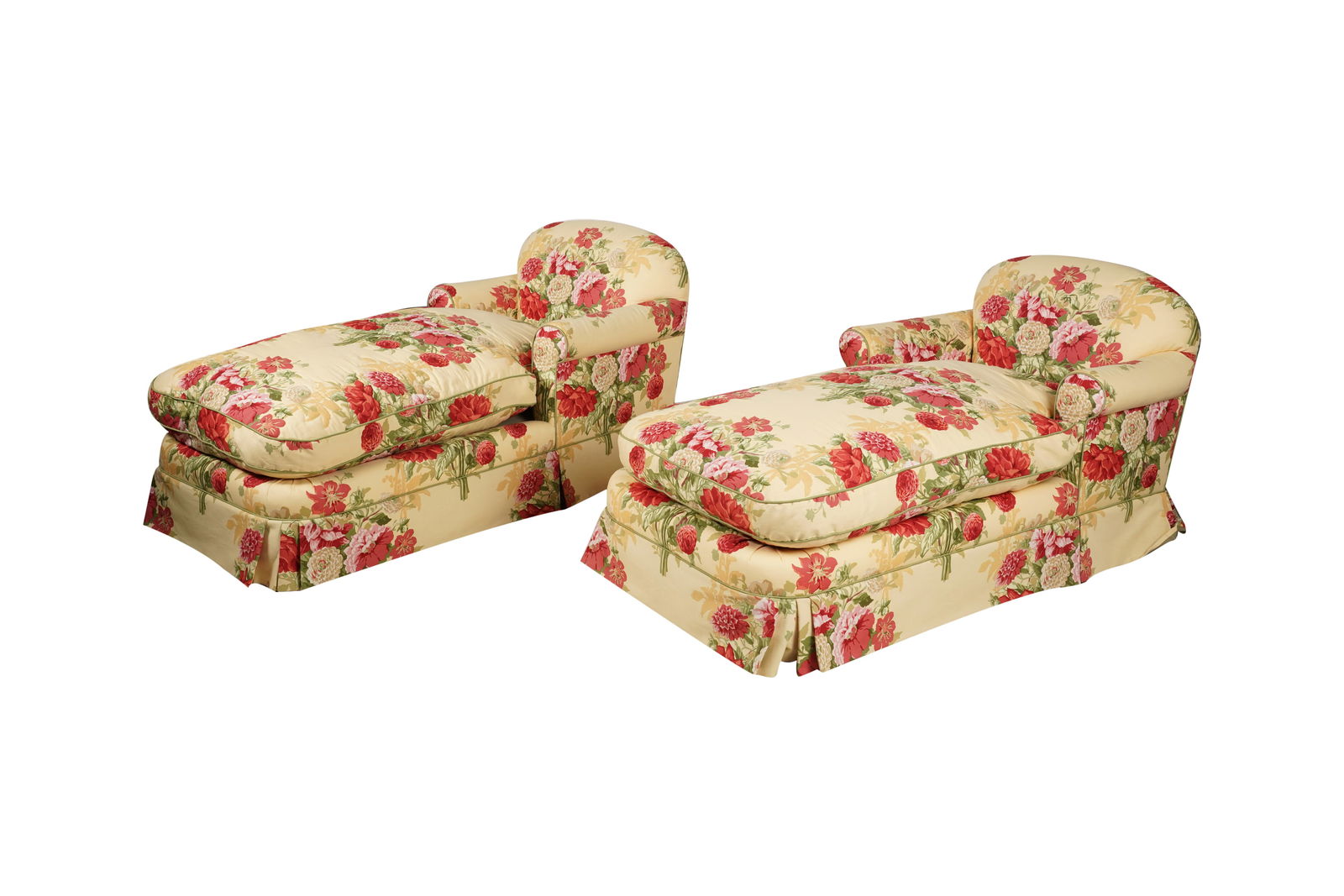 A Pair of Floral Upholstered Chaise Lounges: each with green piping and loose seat cushion 33 x 60 x 34 in. (83.8 x 152.4 x 86.4 cm.)