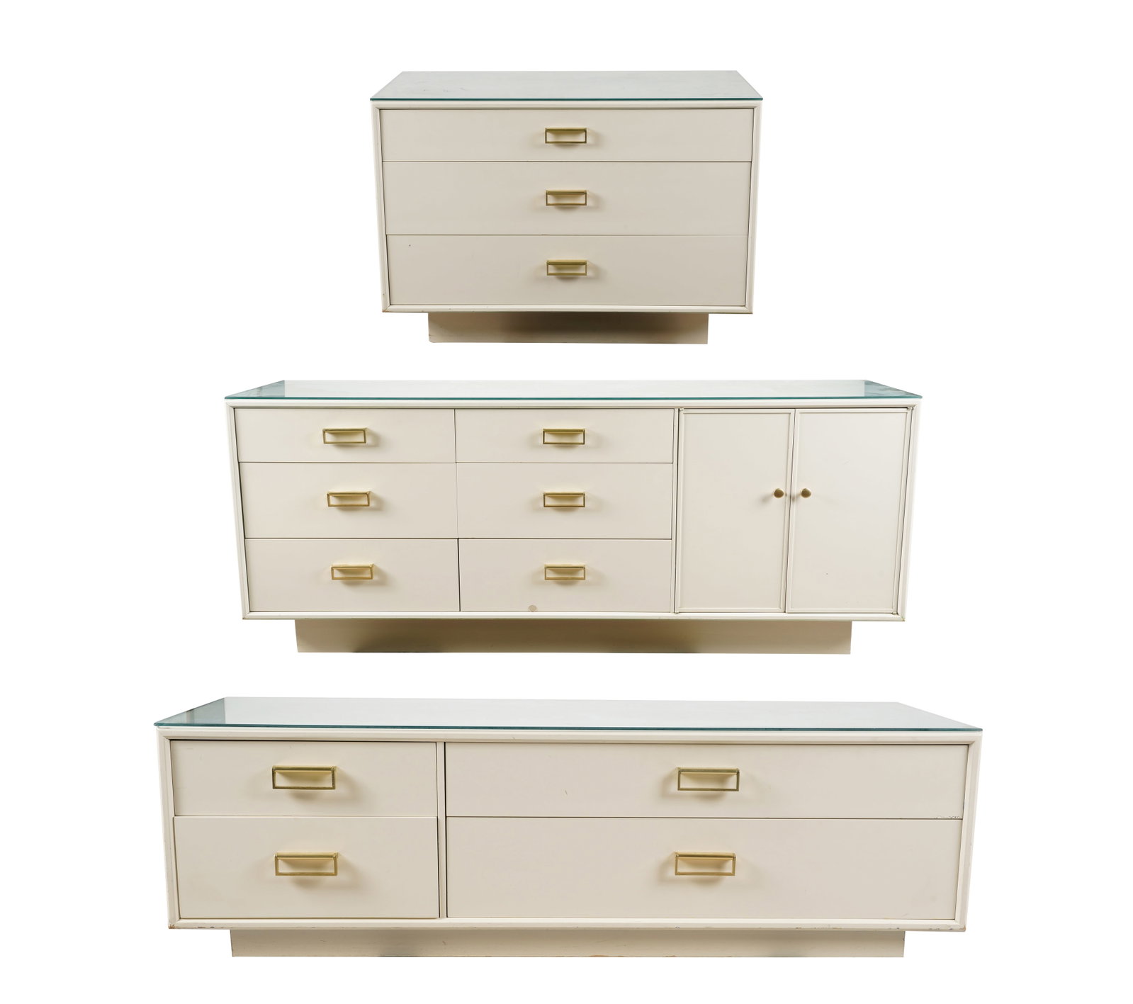 A Drexel Bedroom Set: 1980s; comprising a dresser (27 1/2 x 66 x 18 in.), a low four-drawer cabinet (16 1/2 x 54 x 18 in.), and a three-drawer side cabinet (27 x 38 x 18 in.); each with removable glass cover; each with bra