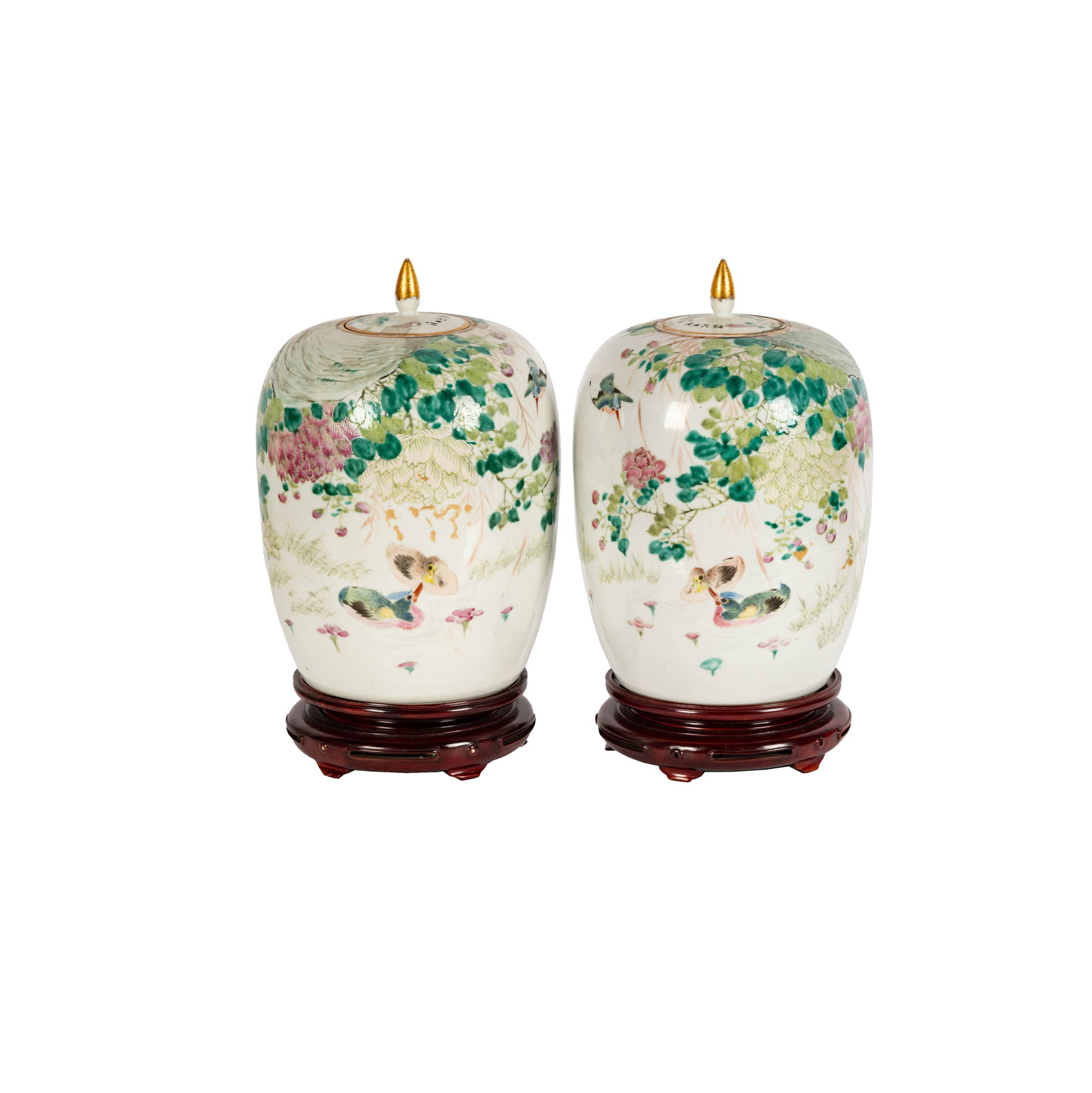 A Pair of Chinese Famille Rose Porcelain Covered Jars: each decorated with ducks on a pond, with flowering branches and birds overhead, and a calligraphic inscription; each with painted mark and wax seal to underside, Each 13 x 8 1/2 in. (33 x 21.6 cm.), 
