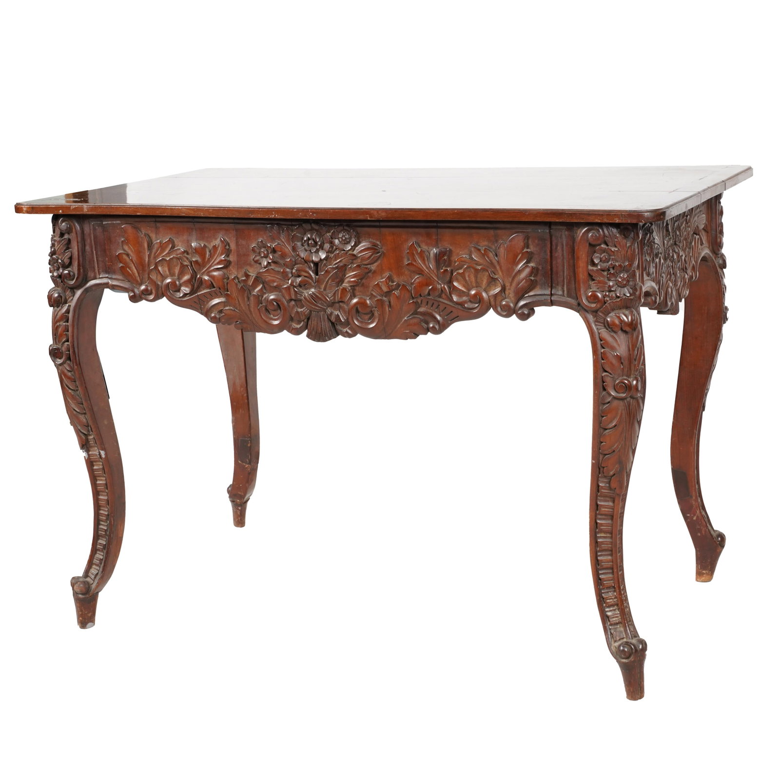 A Louis XV Provincial-Style WritingTable: late 19th/early 20th century; the rectangular top with serpentine front and rear edges and inlaid with a central lozenge-shape motif, over a full-width drawer, the frieze and legs carved with floral s