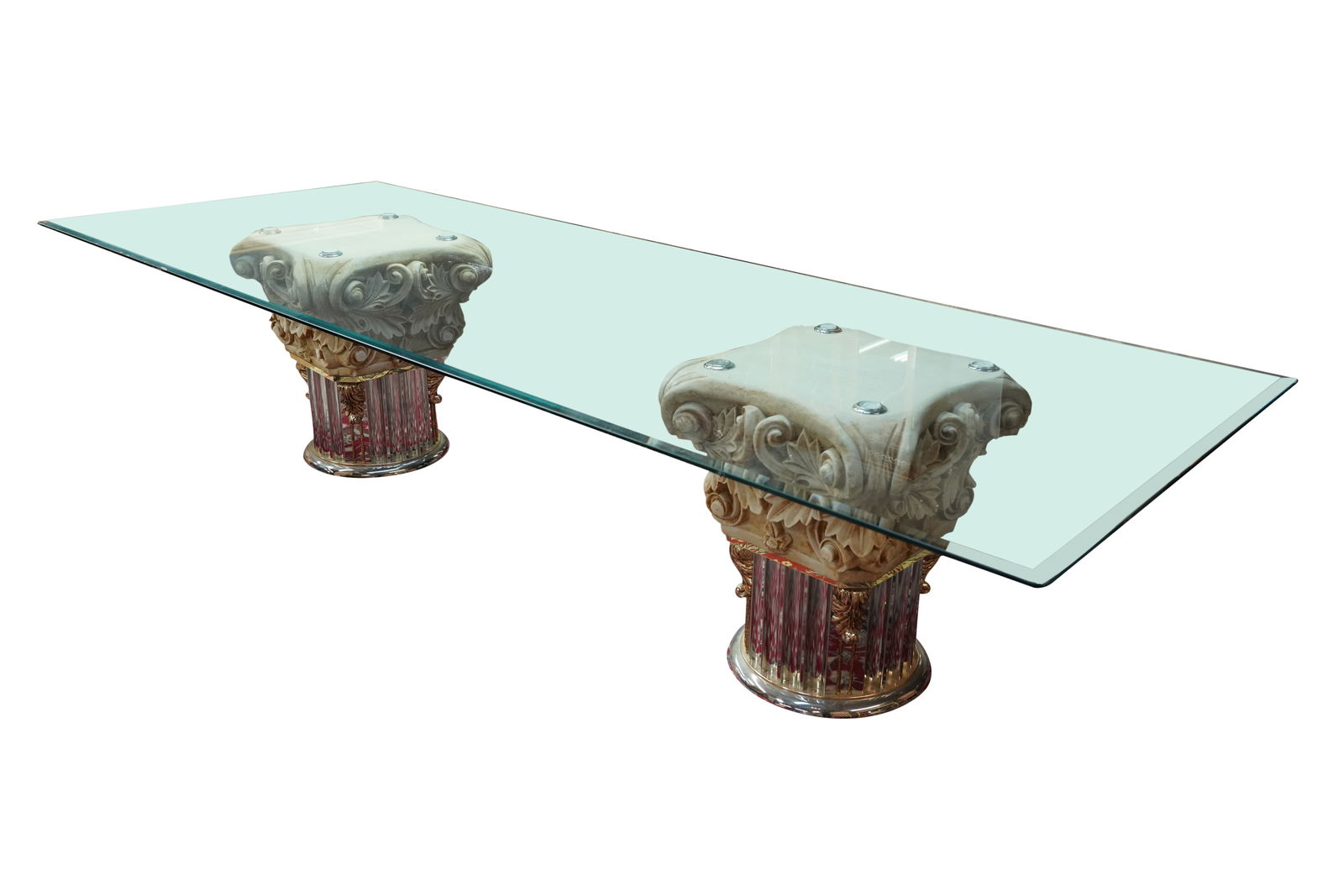 A Neoclassical-Style Dining Table: contemporary; the rectangular glass top with beveled edge, on two cast stone, brass-finish and chromed metal columnar supports 28 1/2 x 132 x 48 in. (72.4 x 335.3 x 121.9 cm.)