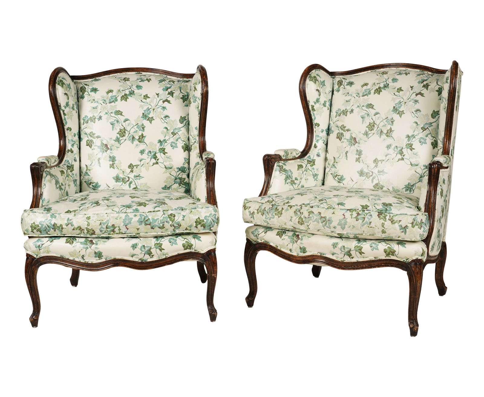 A Pair of Louis XV-Style Walnut Floral Upholstered Wing Chairs: Mid-20th century, polish cotton fabric 40 x 28 x 22 in. (101.6 x 71.1 x 55.9 cm.), Seat Height: 18 in. (45.7 cm.)
