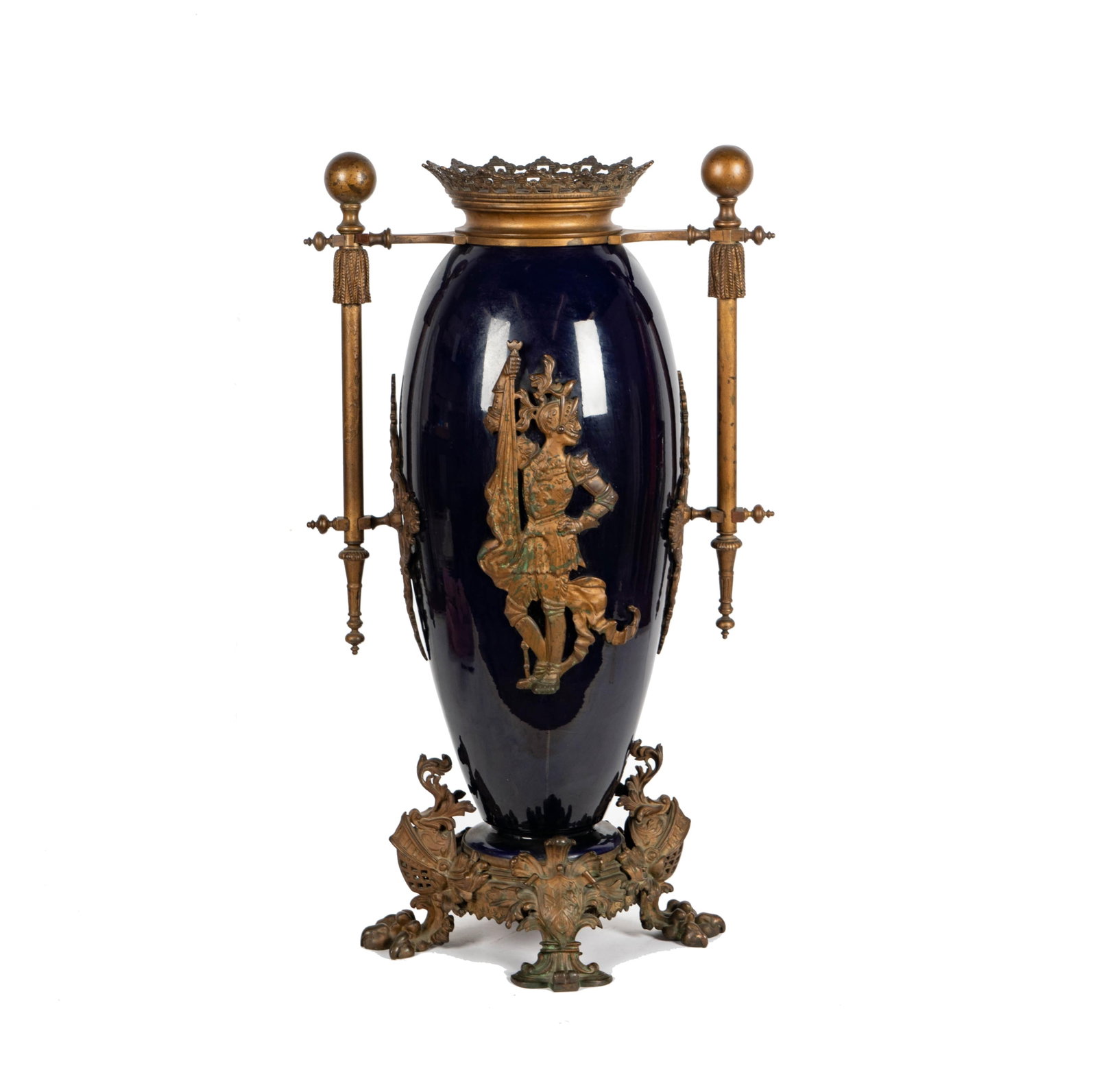A Continental Cobalt Enameled Metal Vase: the body mounted with a figure of knight in armor, the feet cast as plumed helmets 28 1/4 x 16 x 10 in. (71.8 x 40.6 x 25.4 cm.)
